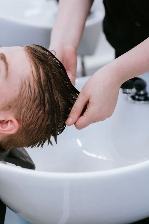 Student washing a client's hair