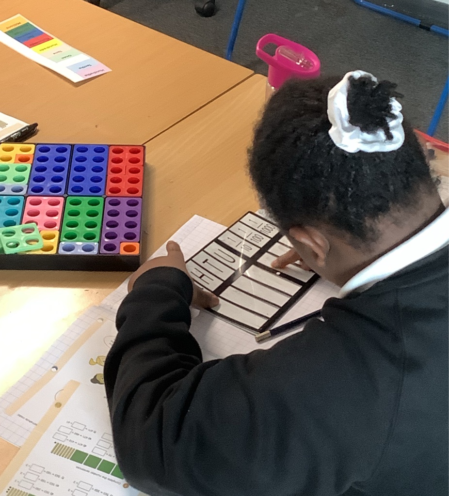 Girl working with numicons in maths